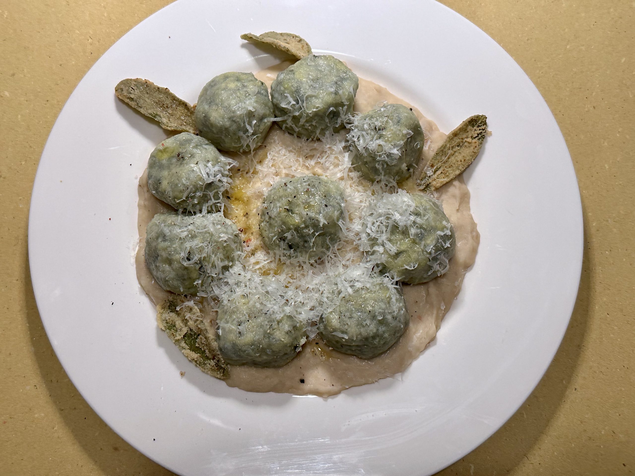 Black cabbage “gnudi” on cannellini mousse and fried sage | Carlo Florence chef