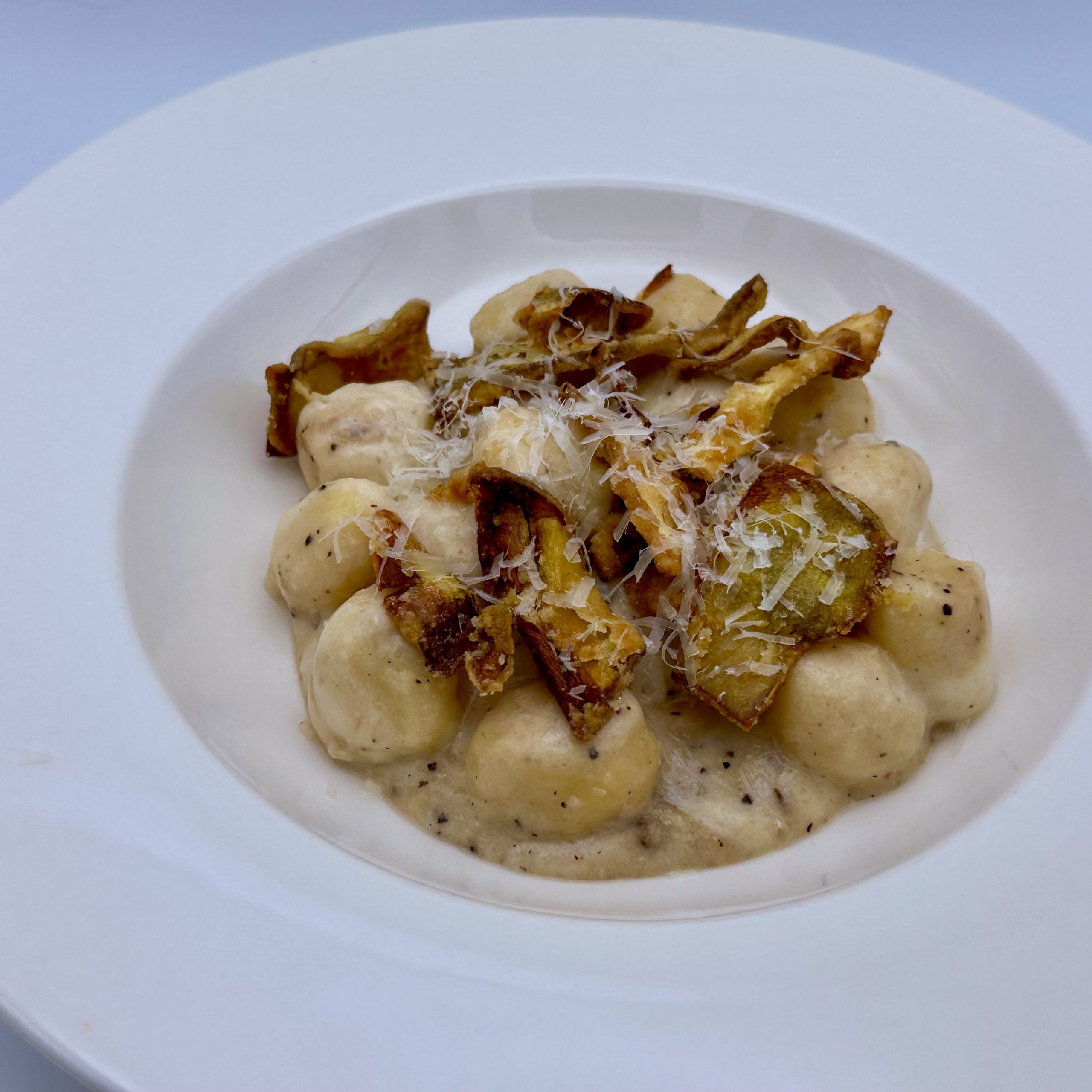 Gnocchi Cacio e Pepe with crispy artichoke leaves | Carlo Florence chef