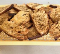 Crispy mini bruschetta cooling on a rack